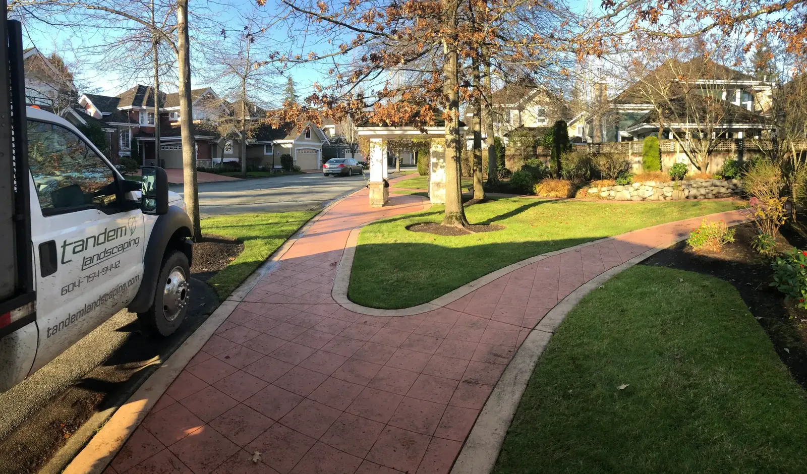 Tandem Landscaping truck beside a maintained strata entrance path